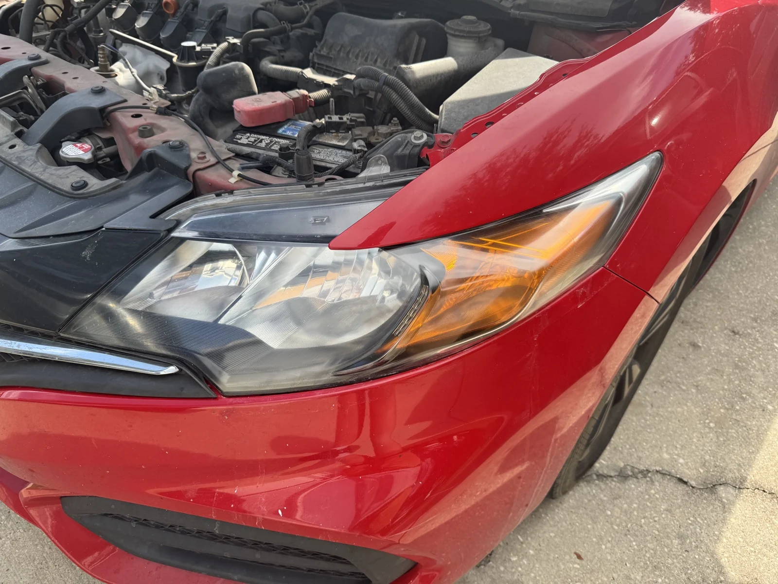 Clearer headlight on a red 2015 Honda Civic after mobile restoration