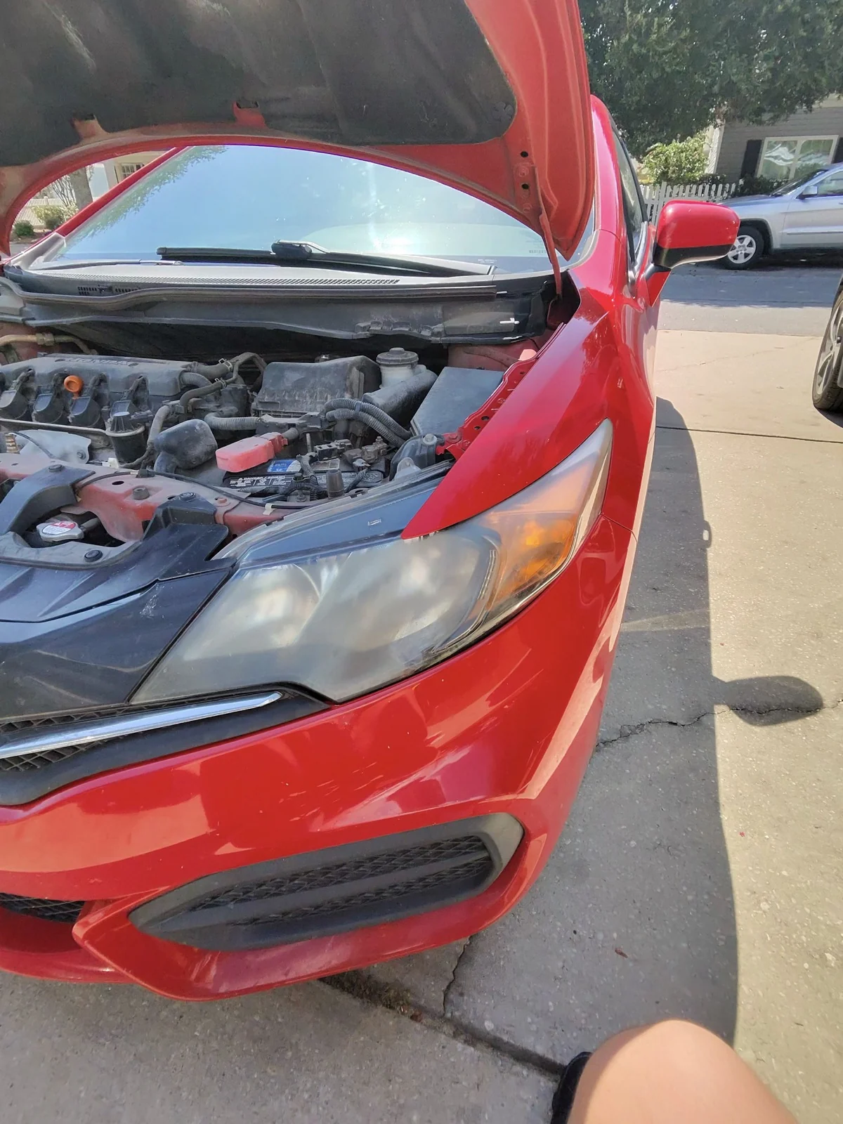Cloudy headlight on a red 2015 Honda Civic before restoration